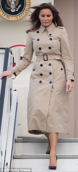 Change: She stepped off Air Force One in Belgium wearing a Burberry trench and different Louboutins
